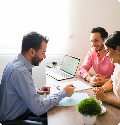 An agent meeting a couple at their kitchen table